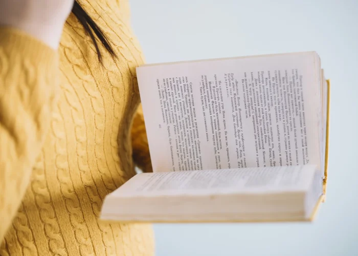 crop-woman-enjoying-reading.opti