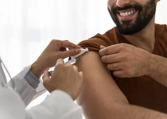 doctor-vaccinating-smiley-man.opti