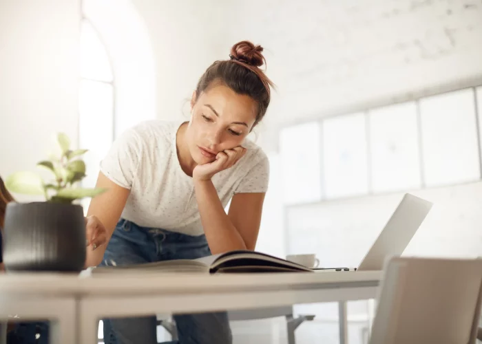 hardworking-woman-working-her-designer-collection-looking-through-fashion-magazine-find-inspiration.opti