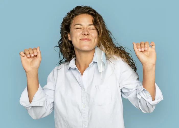 joyful-woman-dancing-blue-background.opti