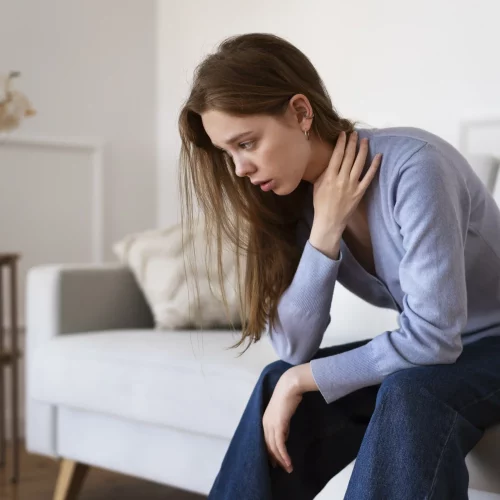 side-view-anxious-woman-sitting-couch.opti